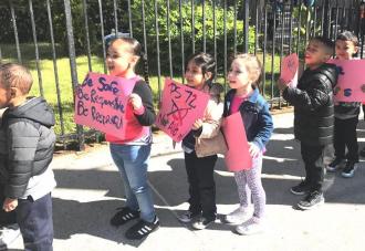 Young students marching holding signs