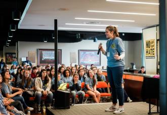 Person speaking on stage at conference