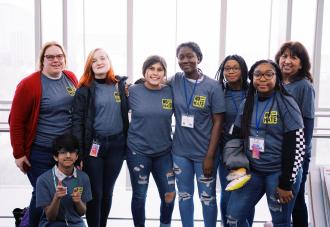 Students linking arms smiling